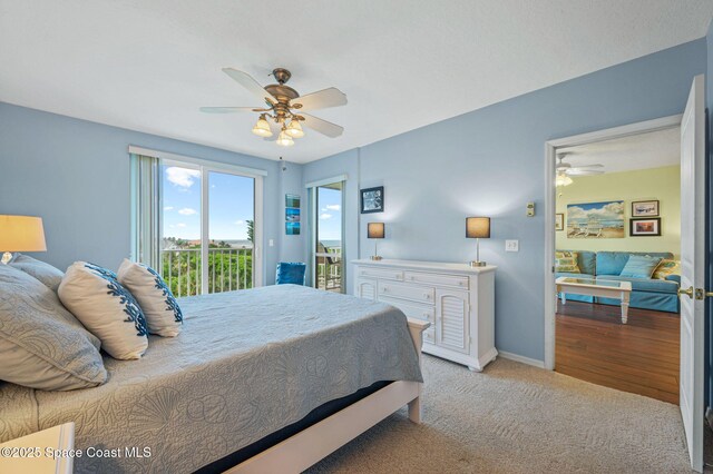 8700 Ridgewood Ave Unit Ph2B, Cape Canaveral, FL 32920 - bedroom with access to outside, carpet flooring, and ceiling fan