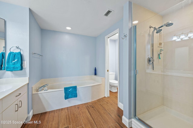 8700 Ridgewood Ave Unit Ph2B, Cape Canaveral, FL 32920 - full bath featuring vanity, a garden tub, a shower stall, and wood finished floors