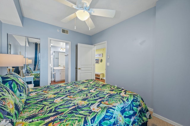 8700 Ridgewood Ave Unit Ph2B, Cape Canaveral, FL 32920 - carpeted bedroom featuring a ceiling fan and connected bathroom