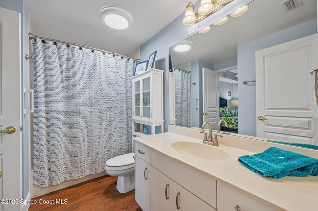 8700 Ridgewood Ave Unit Ph2B, Cape Canaveral, FL 32920 - full bath with vanity, wood finished floors, and curtained shower