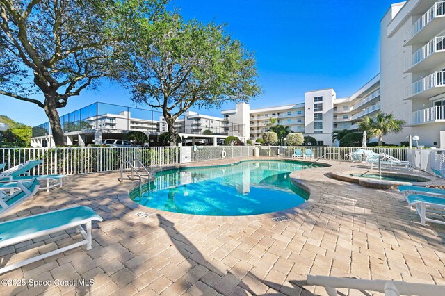 8700 Ridgewood Ave Unit Ph2B, Cape Canaveral, FL 32920 - community pool featuring a hot tub and a patio area
