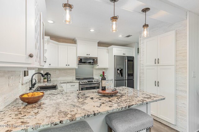 761 Bywood Dr NE, Palm Bay, FL 32905 - kitchen featuring stainless steel appliances, a peninsula, white cabinets, light stone countertops, and decorative backsplash