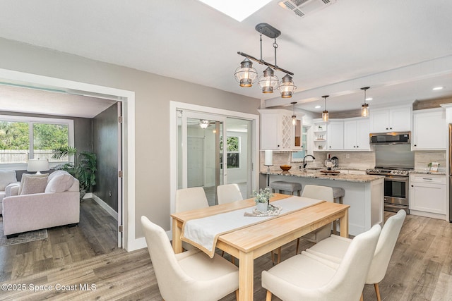 761 Bywood Dr NE, Palm Bay, FL 32905 - dining area with light wood finished floors