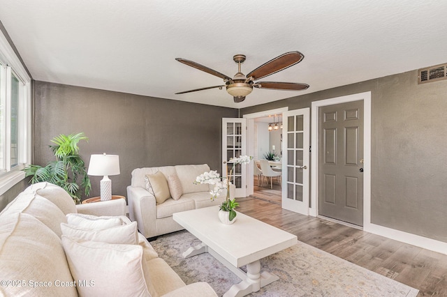 761 Bywood Dr NE, Palm Bay, FL 32905 - living room featuring a ceiling fan, wood finished floors, a textured wall, and french doors