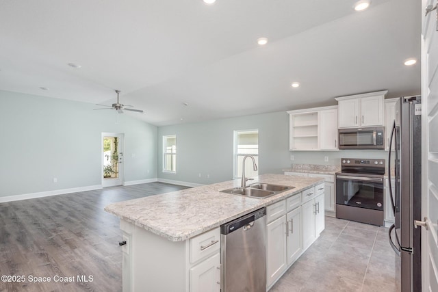 1331 Tupelo Cir, Cocoa, FL 32926 - kitchen with appliances with stainless steel finishes, a sink, a kitchen island with sink, white cabinets, and open shelves