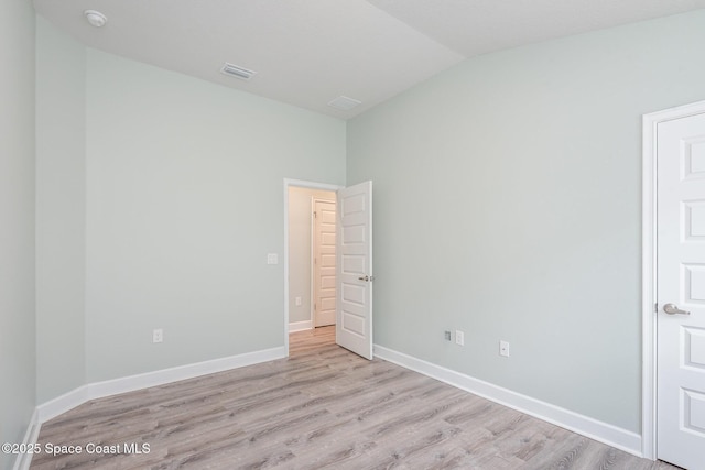 1331 Tupelo Cir, Cocoa, FL 32926 - unfurnished bedroom with lofted ceiling, light wood finished floors, and baseboards
