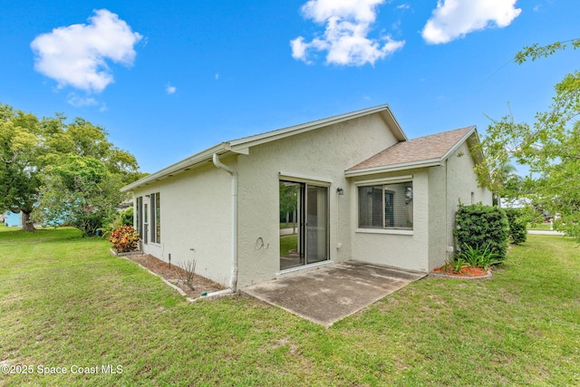 1719 Goldfinch Ct, Melbourne, FL 32935 - rear view of property featuring stucco siding, a lawn, and a patio
