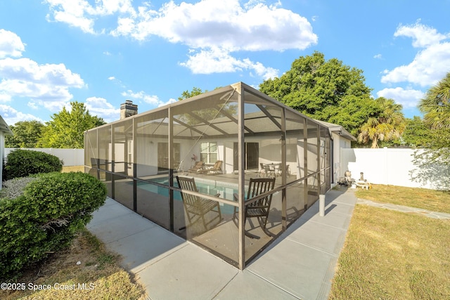 16190 SW 16th Ct, Ocala, FL 34473 - back of property with a patio area, a chimney, and a lanai