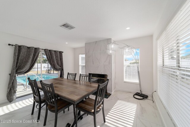 16190 SW 16th Ct, Ocala, FL 34473 - dining space featuring plenty of natural light, a chandelier, light marble finish floors, and recessed lighting