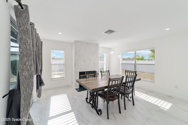 16190 SW 16th Ct, Ocala, FL 34473 - dining space featuring plenty of natural light, a high end fireplace, recessed lighting, light marble finish flooring, and baseboards