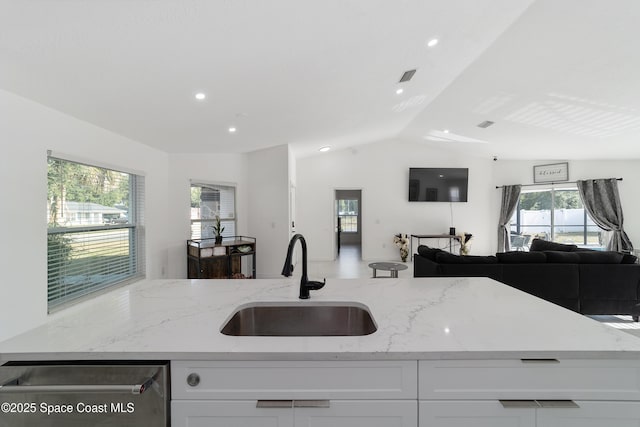 16190 SW 16th Ct, Ocala, FL 34473 - kitchen with a sink, open floor plan, stainless steel dishwasher, light stone countertops, and white cabinets