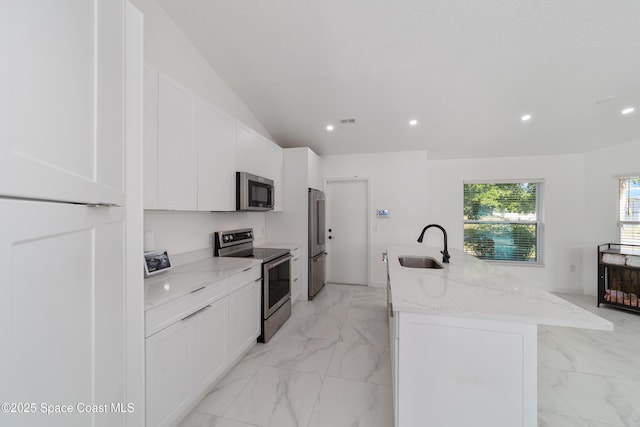 16190 SW 16th Ct, Ocala, FL 34473 - kitchen featuring appliances with stainless steel finishes, a sink, an island with sink, white cabinets, and recessed lighting