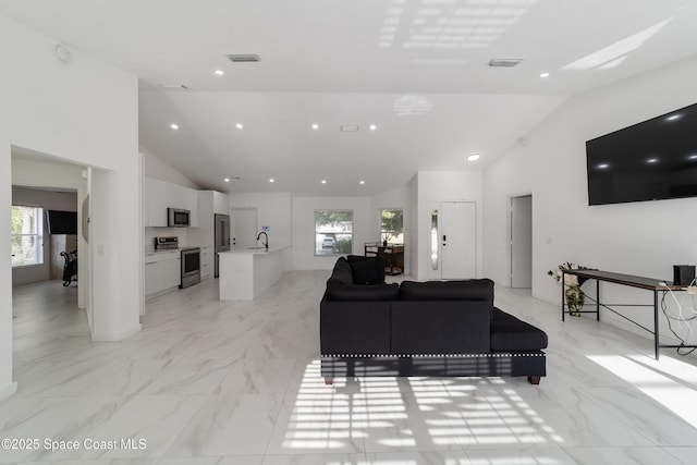 16190 SW 16th Ct, Ocala, FL 34473 - living room featuring plenty of natural light, high vaulted ceiling, light marble finish flooring, and recessed lighting