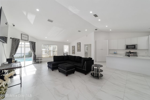 16190 SW 16th Ct, Ocala, FL 34473 - living area featuring high vaulted ceiling, recessed lighting, and light marble finish flooring