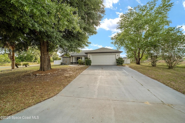 16190 SW 16th Ct, Ocala, FL 34473 - view of front of house with concrete driveway, an attached garage, and a front yard