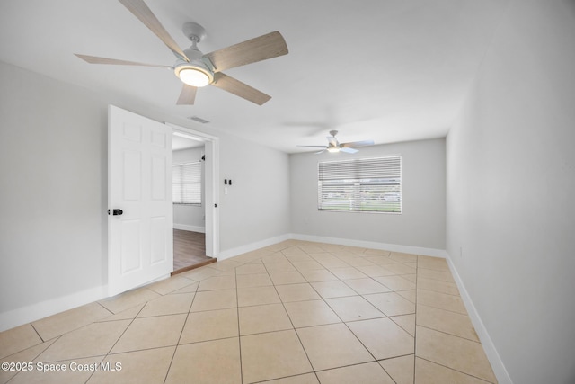 287 Edward Rd, Melbourne, FL 32904 - empty room with a ceiling fan, healthy amount of natural light, and light tile patterned flooring