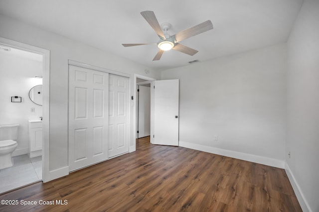 287 Edward Rd, Melbourne, FL 32904 - unfurnished bedroom with a closet, baseboards, wood finished floors, and ensuite bath
