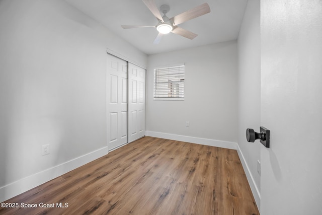 287 Edward Rd, Melbourne, FL 32904 - unfurnished bedroom with a closet, baseboards, wood finished floors, and ceiling fan