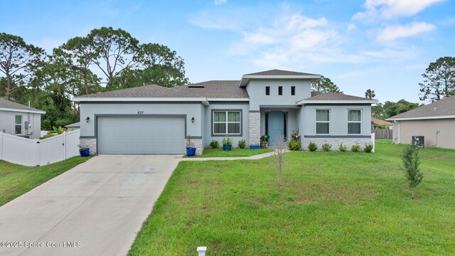 837 Wakaw Ln SW, Palm Bay, FL 32908 - prairie-style home with stone siding, stucco siding, a garage, concrete driveway, and roof with shingles
