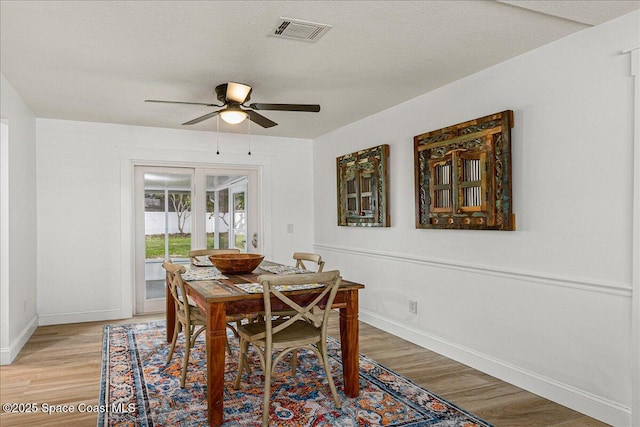 483 Sacre Coeur Dr, Melbourne, FL 32935 - dining room with light wood-style flooring, baseboards, and a ceiling fan