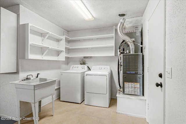 483 Sacre Coeur Dr, Melbourne, FL 32935 - washroom with washer and dryer, light tile patterned floors, and a textured ceiling