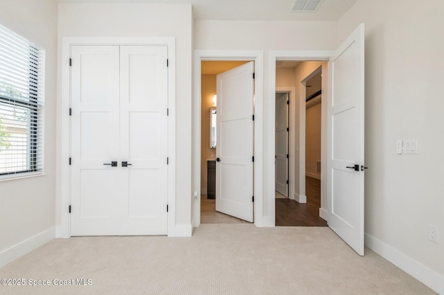 4541 Rosebud St, Cocoa, FL 32927 - unfurnished bedroom featuring light carpet, baseboards, and a closet