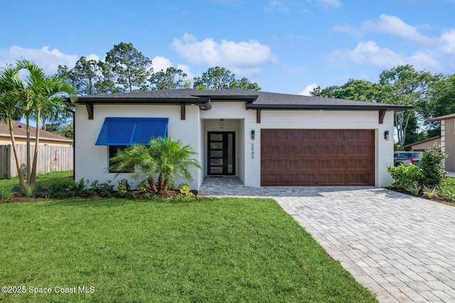 4541 Rosebud St, Cocoa, FL 32927 - view of front of home with an attached garage, stucco siding, and decorative driveway