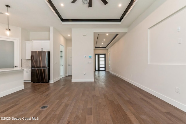 4541 Rosebud St, Cocoa, FL 32927 - unfurnished living room with ceiling fan, a raised ceiling, dark wood-style floors, baseboards, and recessed lighting