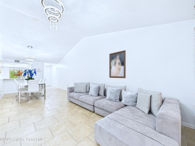 1515 Huntington Ln Unit 924, Rockledge, FL 32955 - living room with lofted ceiling, baseboards, a chandelier, and light tile patterned floors