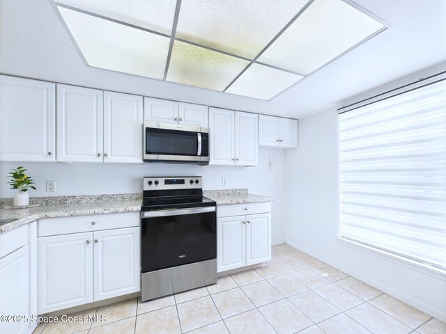 1515 Huntington Ln Unit 924, Rockledge, FL 32955 - kitchen with appliances with stainless steel finishes, white cabinets, and healthy amount of natural light