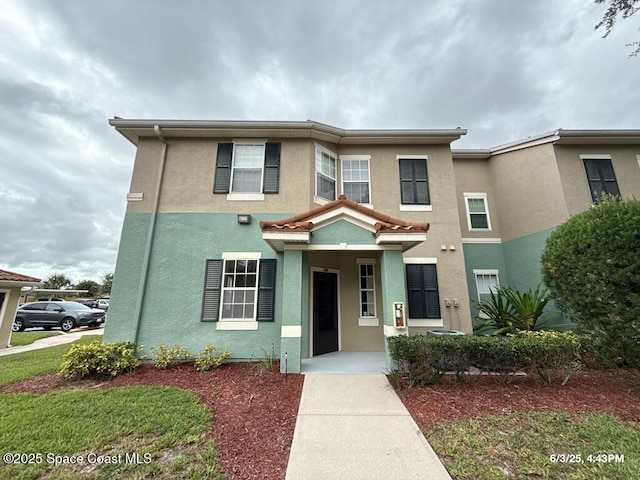 5663 Star Rush Dr Unit 107, Melbourne, FL 32940 - view of front facade featuring stucco siding