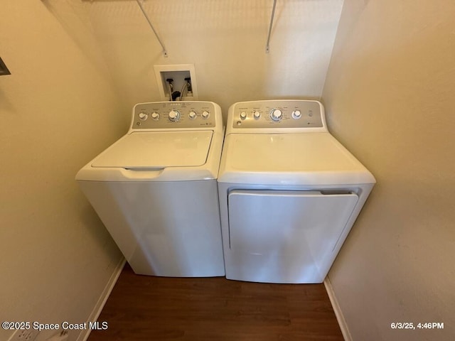 5663 Star Rush Dr Unit 107, Melbourne, FL 32940 - laundry area with washing machine and clothes dryer, wood finished floors, and baseboards