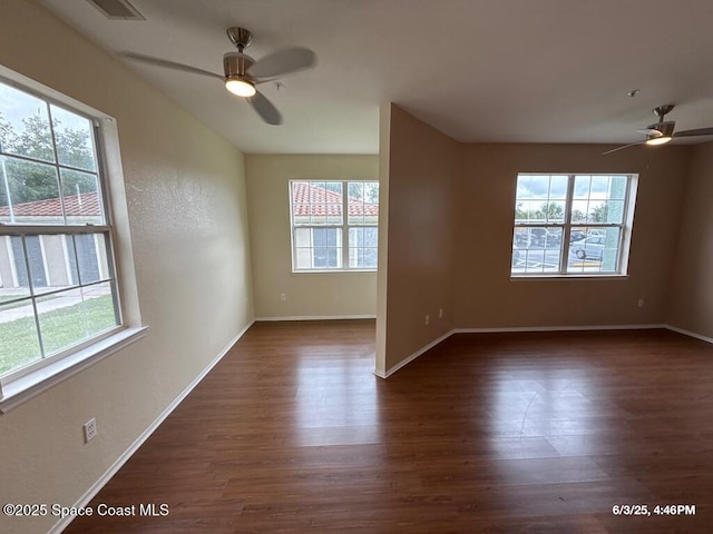 5663 Star Rush Dr Unit 107, Melbourne, FL 32940 - spare room with ceiling fan, dark wood finished floors, and plenty of natural light