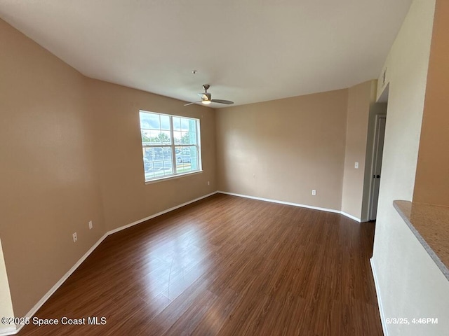 5663 Star Rush Dr Unit 107, Melbourne, FL 32940 - unfurnished room featuring a ceiling fan, dark wood finished floors, and baseboards