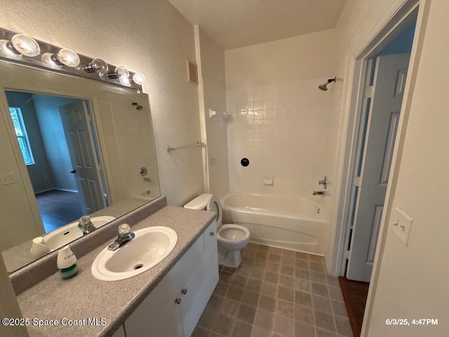 5663 Star Rush Dr Unit 107, Melbourne, FL 32940 - bathroom featuring vanity, toilet, bathing tub / shower combination, and a textured wall