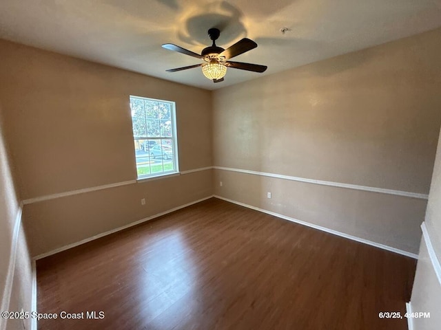 5663 Star Rush Dr Unit 107, Melbourne, FL 32940 - spare room with dark wood finished floors, baseboards, a ceiling fan, and fire sprinkler in ceiling
