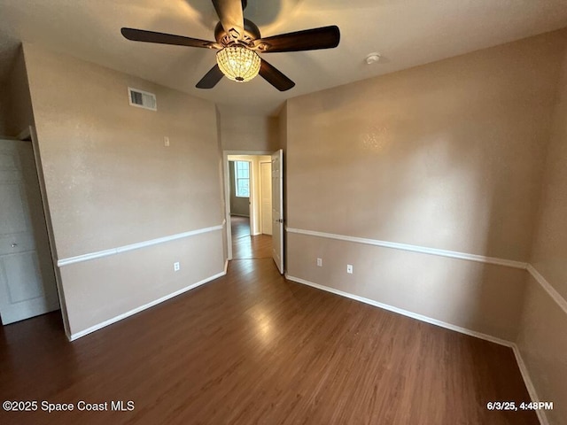 5663 Star Rush Dr Unit 107, Melbourne, FL 32940 - spare room featuring wood finished floors, baseboards, and ceiling fan