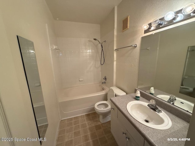 5663 Star Rush Dr Unit 107, Melbourne, FL 32940 - bathroom featuring toilet, vanity, tub / shower combination, and a textured wall