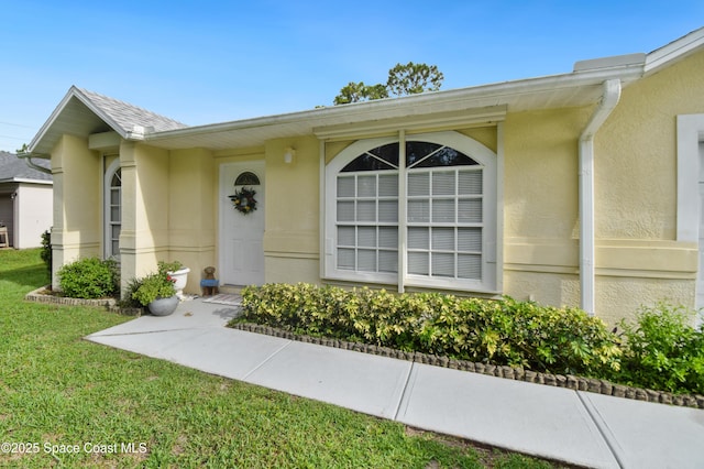 1790 Seeley Cir NW, Palm Bay, FL 32907 - property entrance featuring stucco siding and a yard
