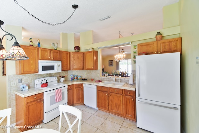 1790 Seeley Cir NW, Palm Bay, FL 32907 - kitchen featuring white appliances, a sink, backsplash, a chandelier, and brown cabinets