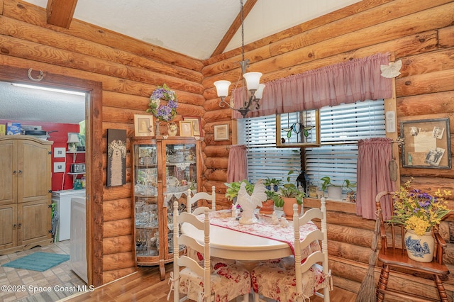 4390 Everglades St, Cocoa, FL 32927 - dining room with lofted ceiling, a chandelier, rustic walls, wood finished floors, and a textured ceiling