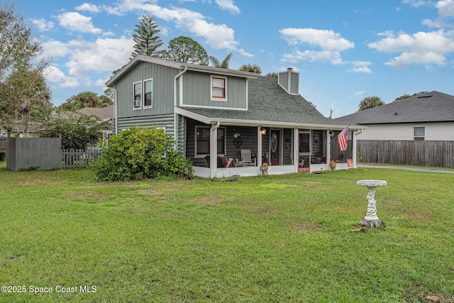 4390 Everglades St, Cocoa, FL 32927 - back of house with a sunroom, a chimney, and roof with shingles