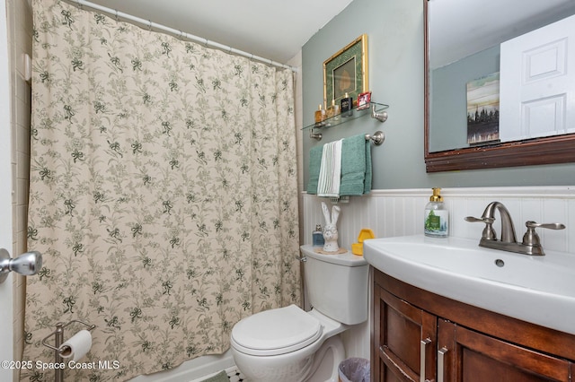 4390 Everglades St, Cocoa, FL 32927 - bathroom featuring vanity, toilet, a shower with shower curtain, and a wainscoted wall
