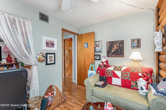 4390 Everglades St, Cocoa, FL 32927 - living area featuring wood finished floors, a ceiling fan, and a textured ceiling