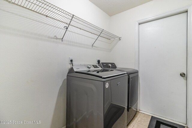251 District St SE, Palm Bay, FL 32909 - washroom featuring washer and dryer and light tile patterned floors