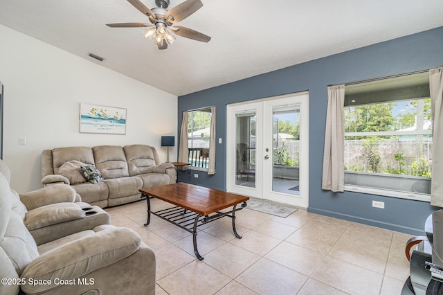 251 District St SE, Palm Bay, FL 32909 - living room with vaulted ceiling, french doors, light tile patterned floors, ceiling fan, and baseboards