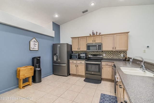 251 District St SE, Palm Bay, FL 32909 - kitchen featuring appliances with stainless steel finishes, a sink, decorative backsplash, light tile patterned floors, and light brown cabinets