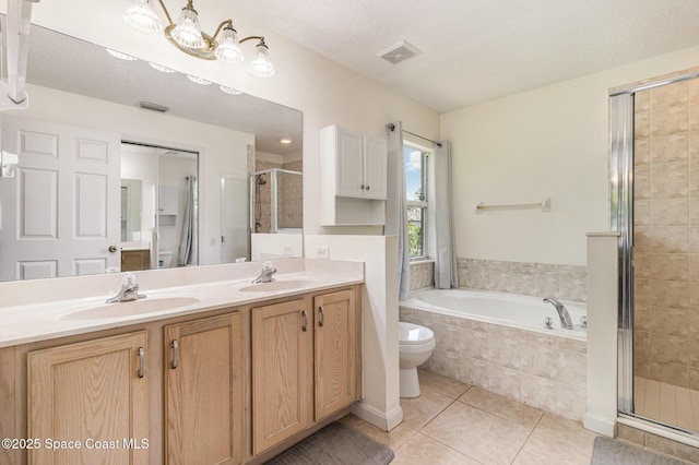 251 District St SE, Palm Bay, FL 32909 - bathroom featuring a shower stall, tile patterned flooring, a garden tub, double vanity, and toilet