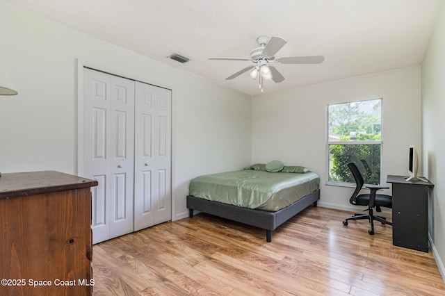 251 District St SE, Palm Bay, FL 32909 - bedroom featuring light wood-type flooring, a closet, a ceiling fan, and baseboards