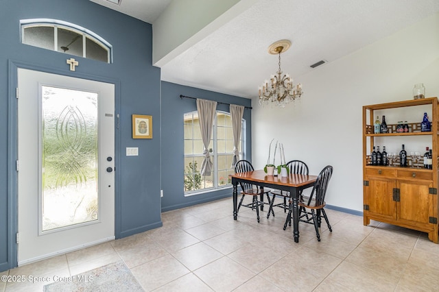 251 District St SE, Palm Bay, FL 32909 - dining area with a chandelier, light tile patterned flooring, and baseboards